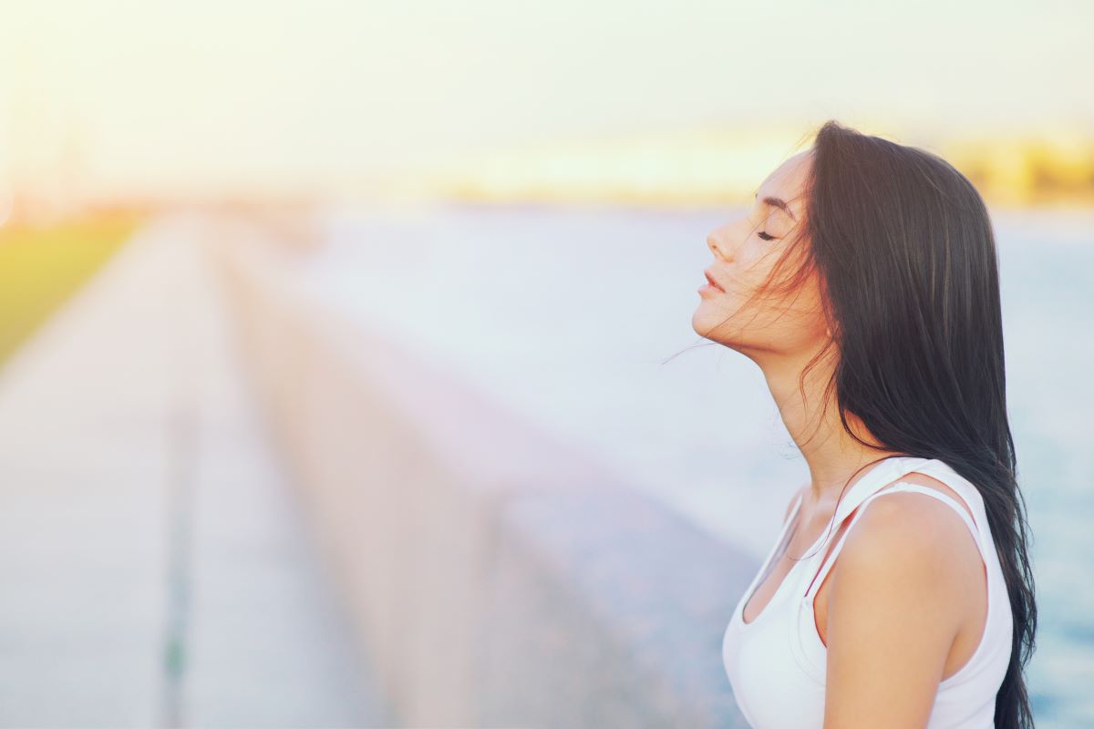 Skin specialist examining sun-damaged skin during a professional skin evaluation.